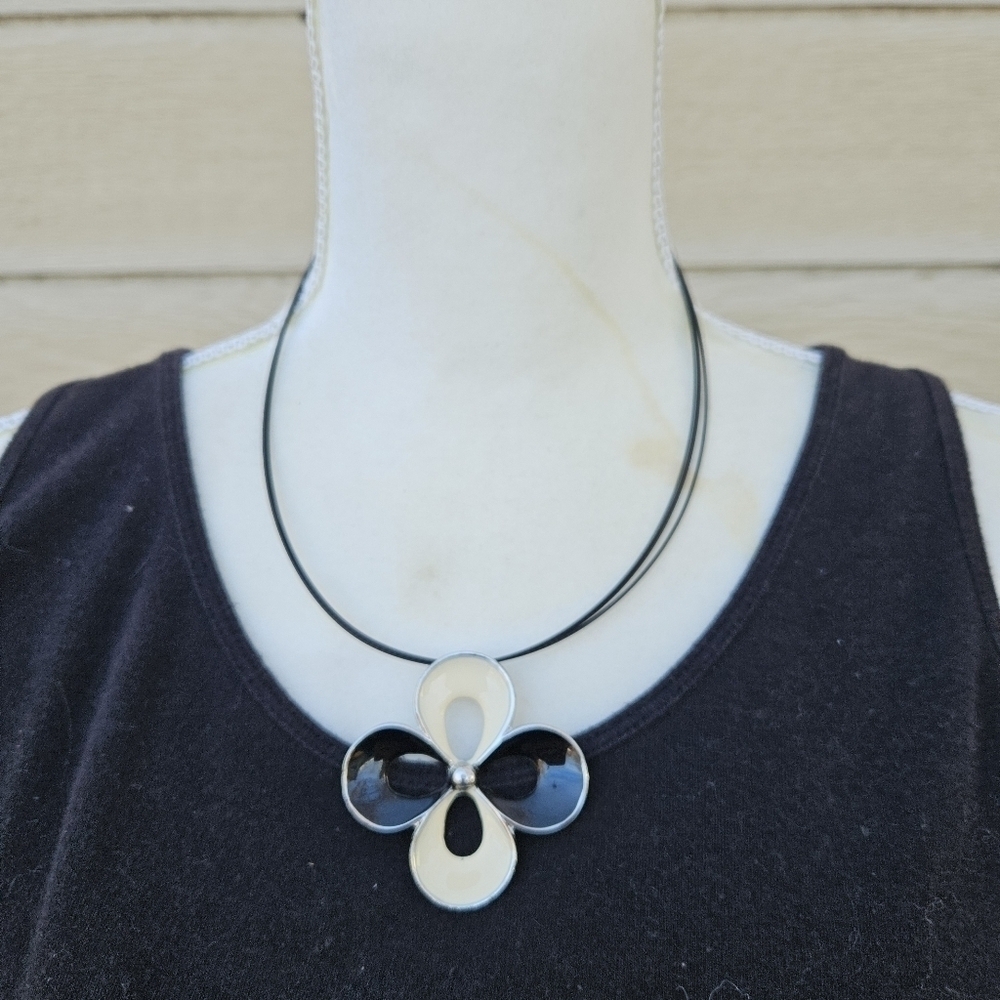 black and cream quatrefoil pendant necklace on black cord